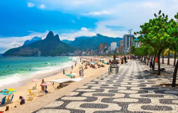 Retirees enjoy coffee at a vibrant Brazilian cafe with ocean views and colorful architecture.