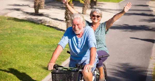 Retired couple enjoying breakfast on a sunny terrace with Panama City skyline in the background.