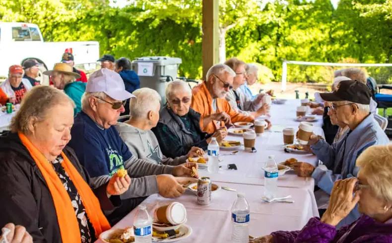 Retirees engaging with artisans at a vibrant European market, learning crafts and enjoying delicacies.