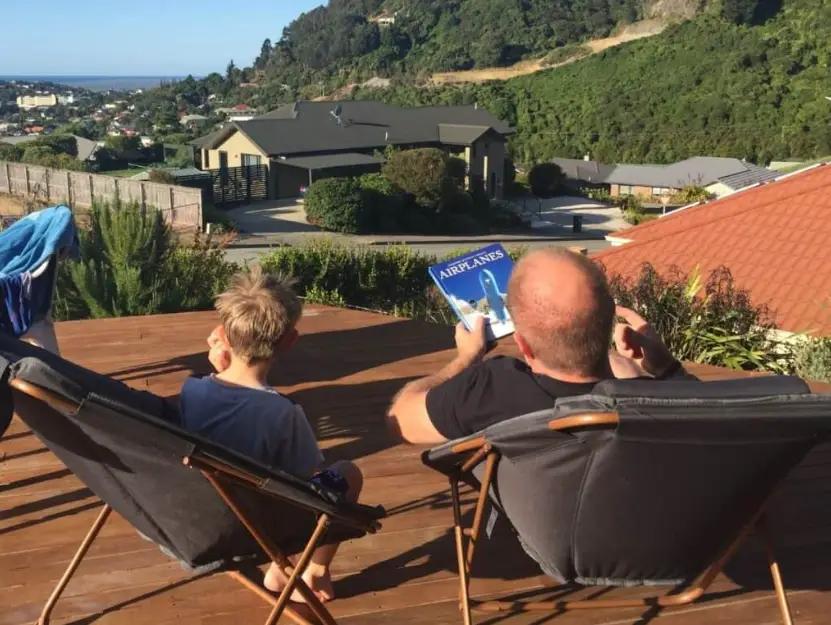 Elderly couple enjoying coffee on the terrace of their secure European seaside villa.